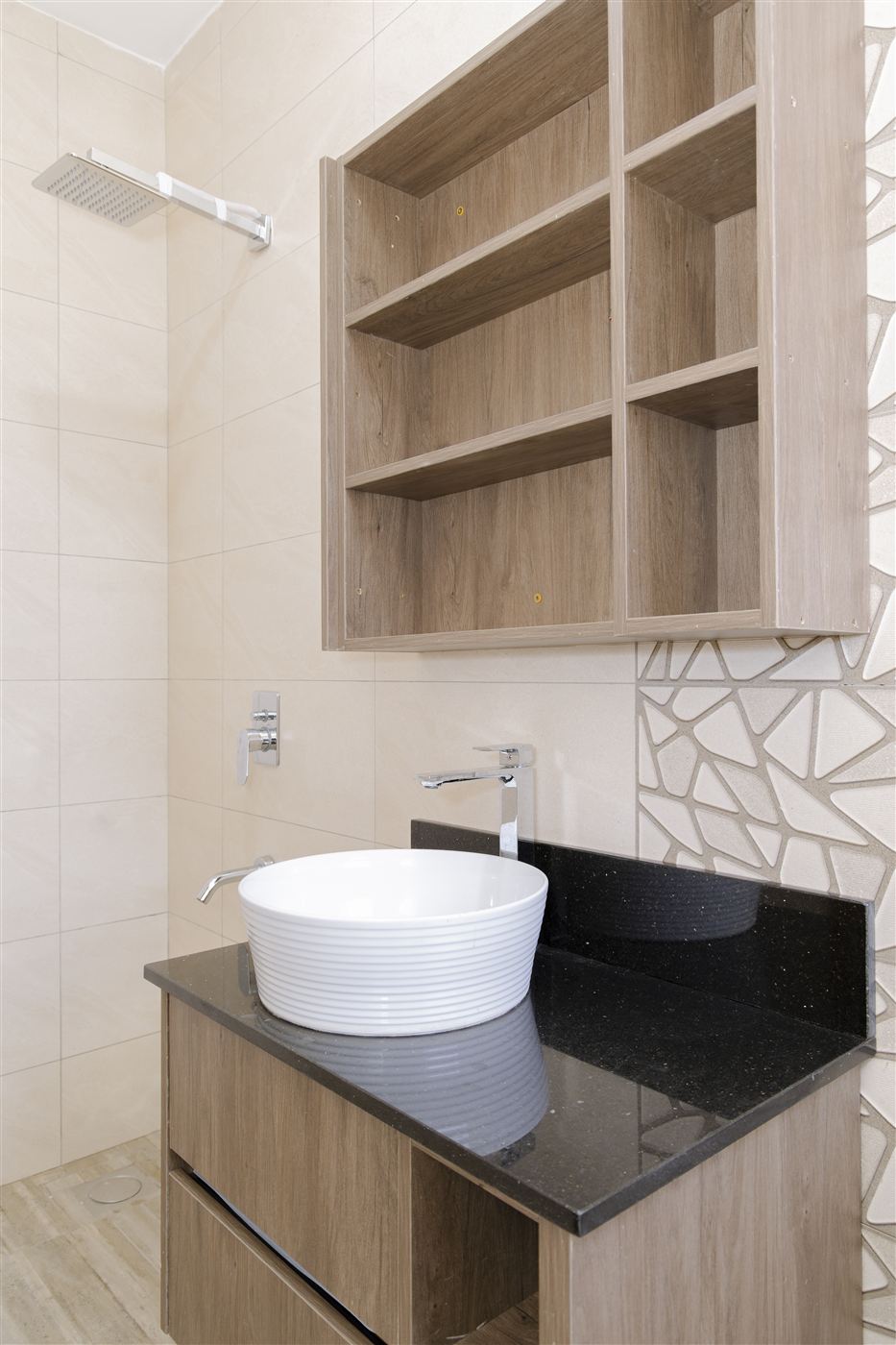 Vessel sink vanity with black granite counter and timber shelving