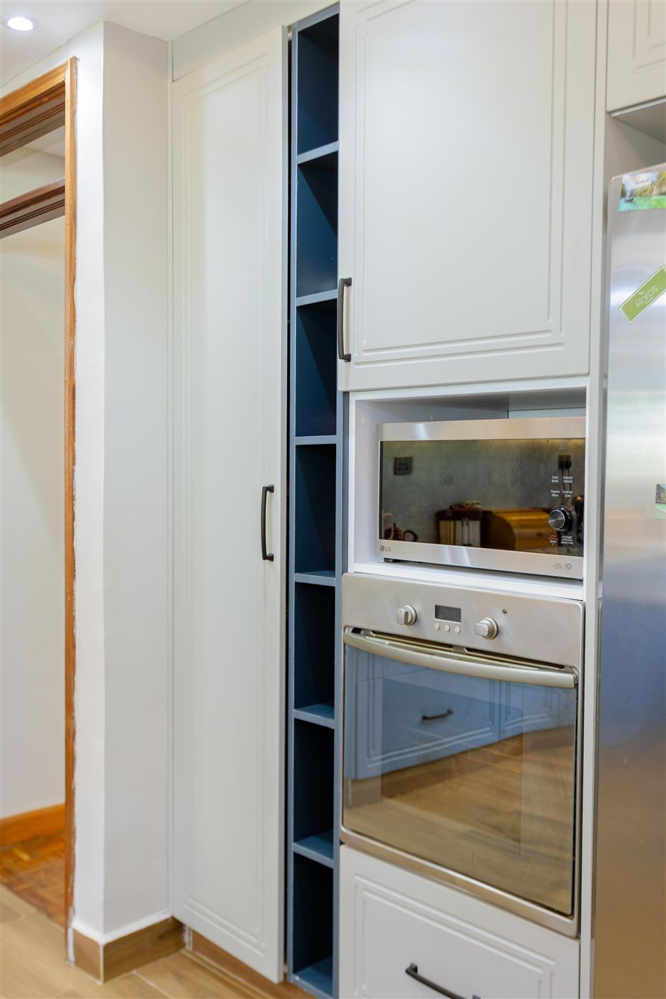 Built-in oven and microwave column with tall pantry cabinetry