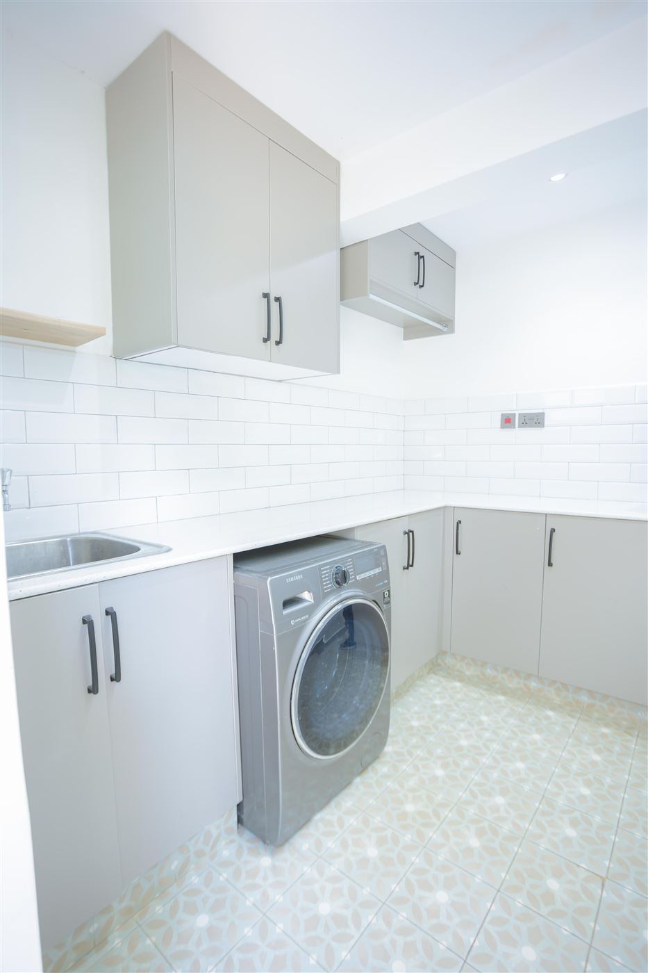 Utility and laundry room with cabinetry, sink and washing machine